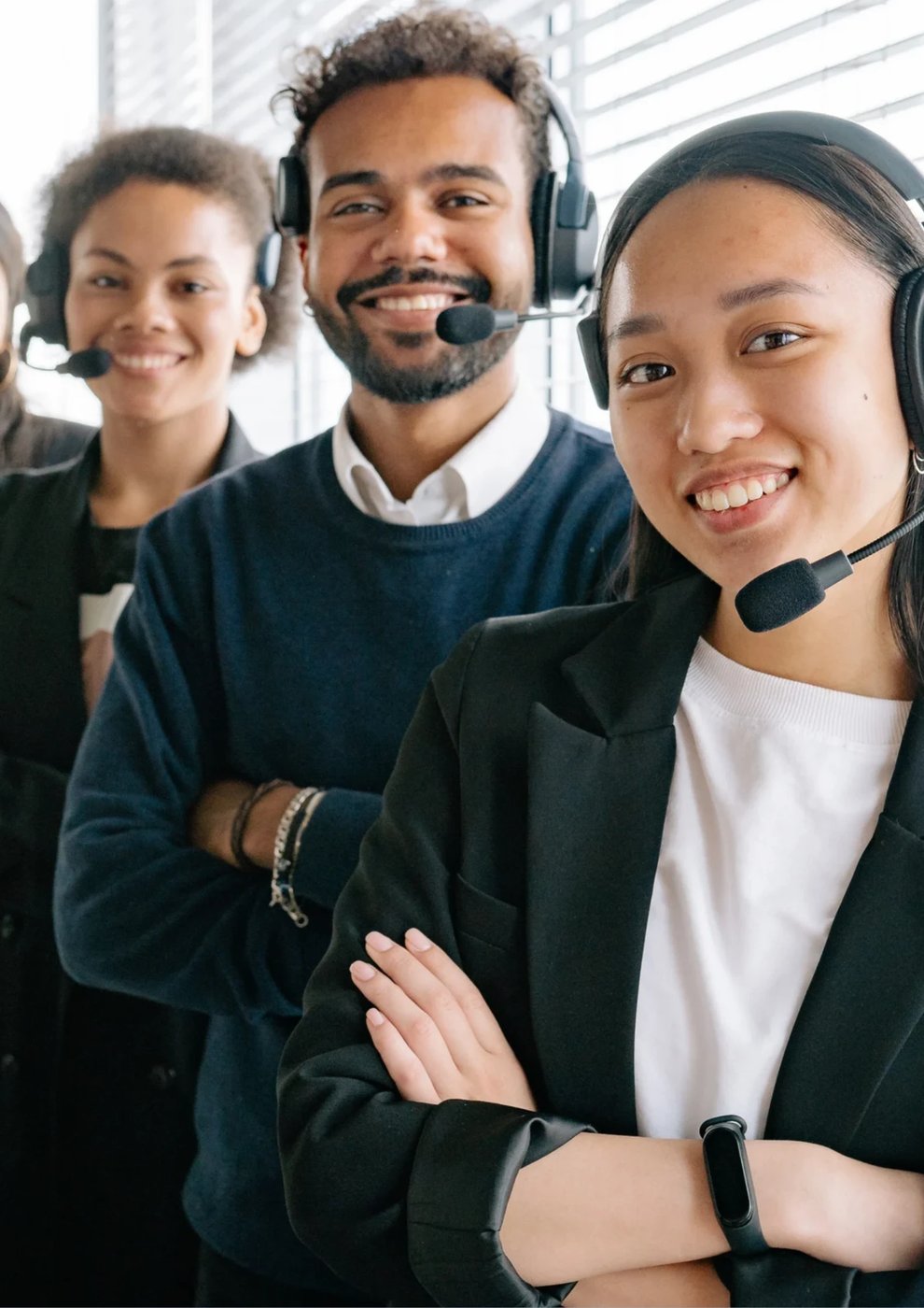 A smiling team wearing headsets